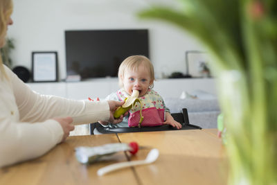 Portrait of cute girl playing on table