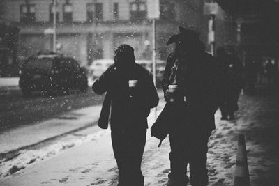 People walking on sidewalk during winter