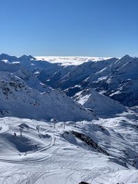 Scenic view of snowcapped mountains against clear sky