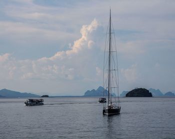 Sailboat sailing on sea against sky