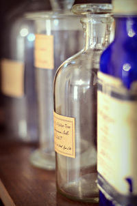 Close-up of glass containers with label on table