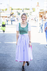 Portrait of smiling woman standing on street