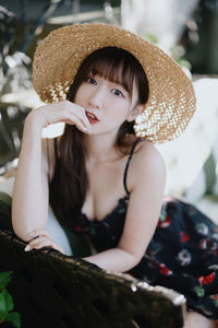 Portrait of young woman wearing hat