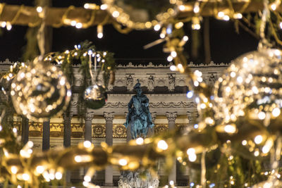 Low angle view of illuminated statue at night