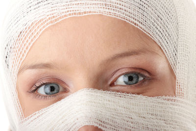 Close-up portrait of woman face wrapped with bandage