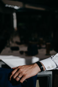 Cropped hand of businessman on desk in office