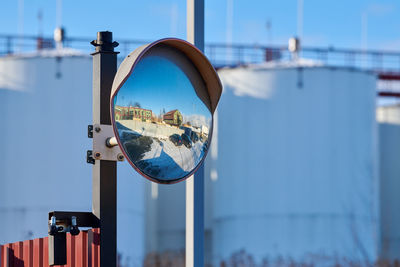 Close-up of reflection of building against sky