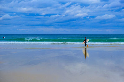 Full length of man on beach against sky