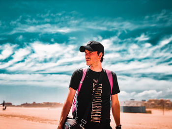 Young man standing on beach