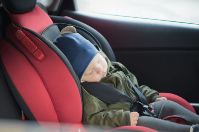 Cute baby boy sleeping in car