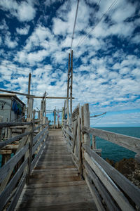 Pier amidst sea against sky