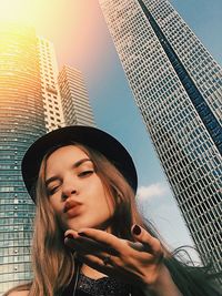 Low angle portrait of woman looking at city