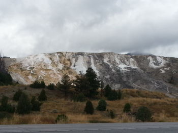Scenic view of mountains against cloudy sky