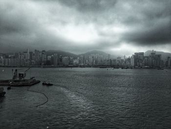 Buildings in city against cloudy sky