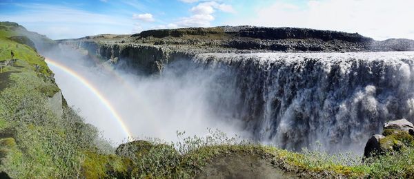 Panoramic view of waterfall against sky