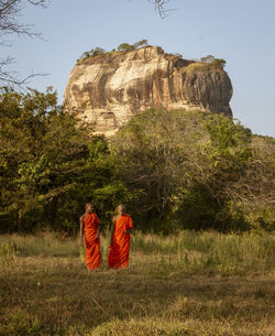 Rear view of people walking in temple