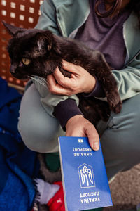 Girl flee from ukraine with cat and ukrainian passport waiting for help and registration border 