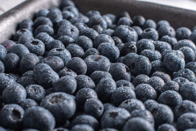 Big box with scattered fresh blueberries, fresh raw food, natural healthy food