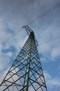 Low angle view of electricity pylon against sky