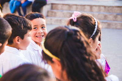 Portrait of a smiling girl with people