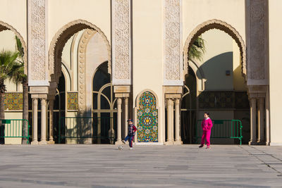 Rear view of people walking in historic building