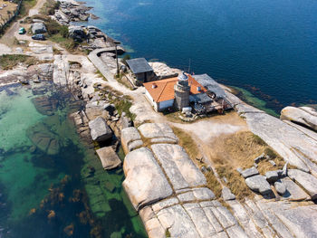 Aerial dron view of punta cabalo lighthouse in arousa island, spain.