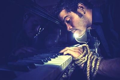 Close-up of man playing piano