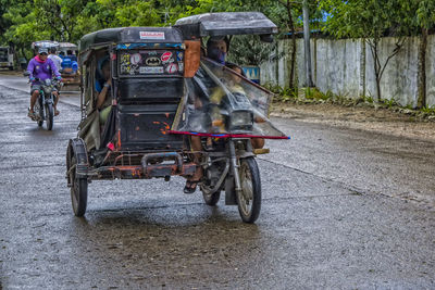 Low section of woman on road by street