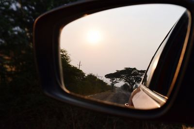 Reflection of clouds in side-view mirror