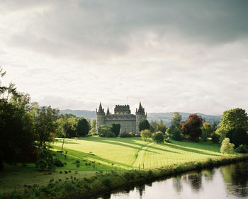 Scenic view of field against cloudy sky