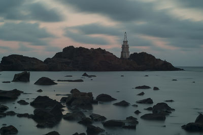 Scenic view of rocks in sea against sky