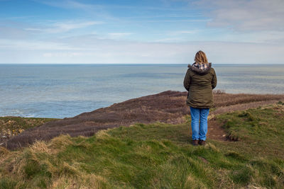 Rear view of woman looking at sea shore