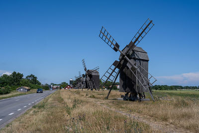 Traditional windmill on field against clear sky