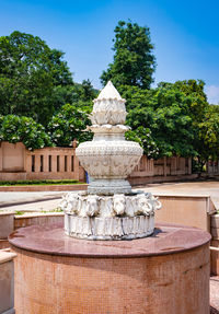 Artistic white marble jain temple holy pillar with bright blue sky at morning 