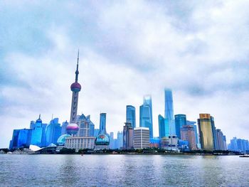 City skyline against cloudy sky