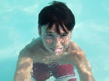 Portrait of young woman in water