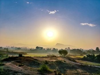 Scenic view of field against sky during sunset