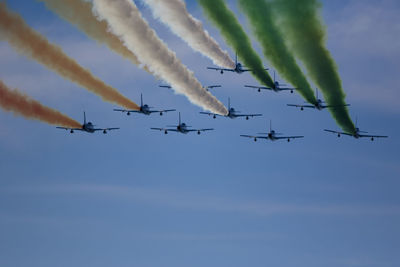 Low angle view of airshow against sky