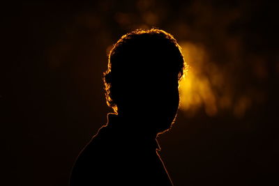 Close-up of silhouette person against black background