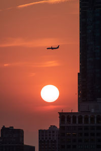 Low angle view of buildings against sky during sunset