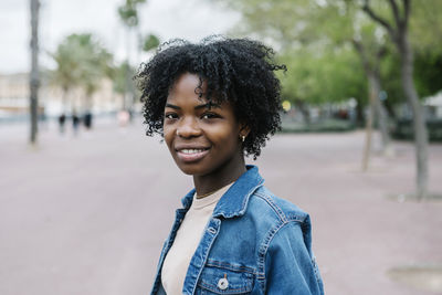 Portrait of a smiling young woman in city