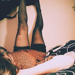 Low section of woman lying on tiled floor