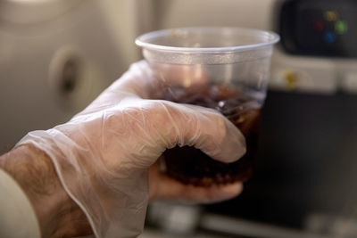 Close-up of hand holding coffee cup