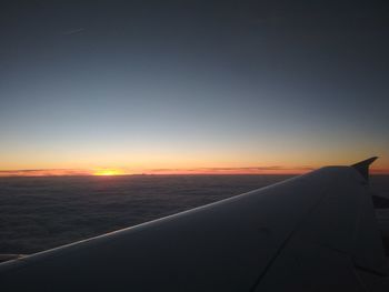 Close-up of airplane wing against clear sky