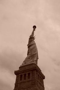 Low angle view of statue against cloudy sky