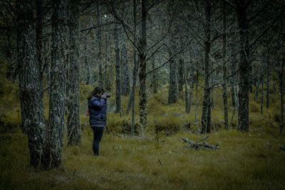 Full length rear view of man walking in forest