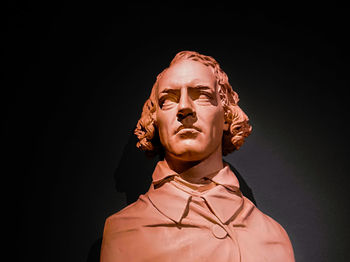 Low angle view of statue against black background