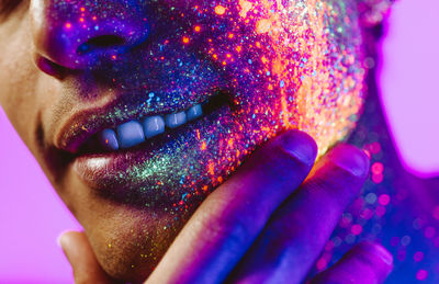 Close-up of man with multi colored face paint