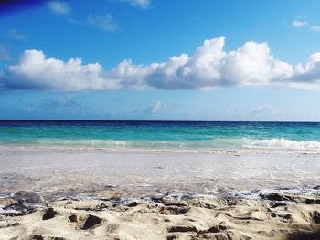 Scenic view of sandy beach against sky