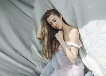 High angle view of woman lying on bed